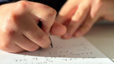 young hands writing a note